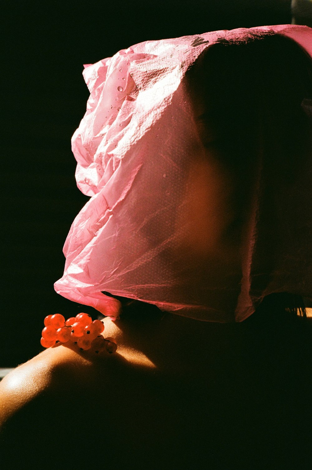 a woman wearing a pink hat with flowers on it