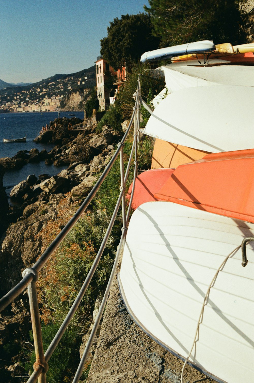 a row of surfboards sitting on the side of a cliff