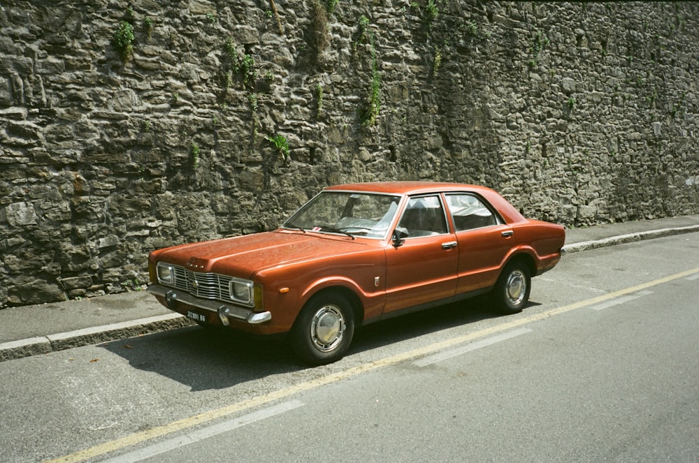 an orange car parked on the side of the road