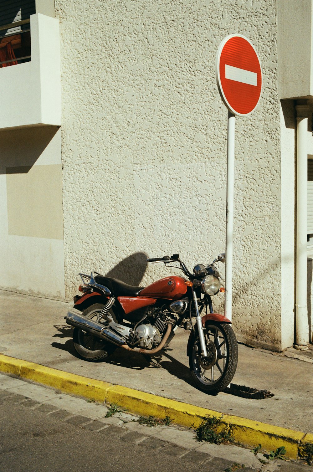 a motorcycle parked next to a no parking sign