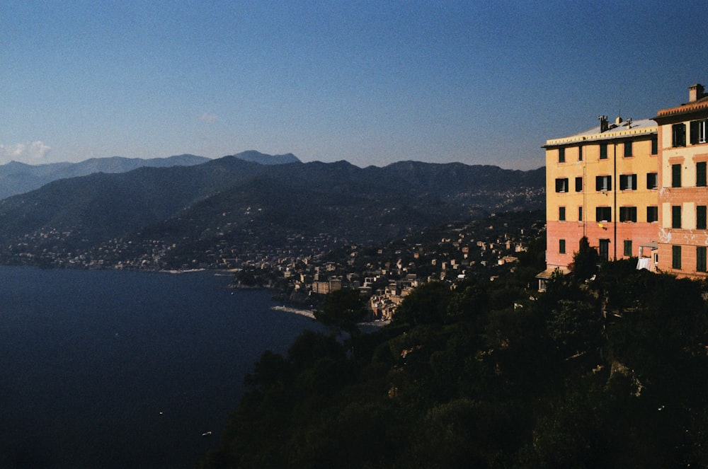a building on a hill overlooking a body of water