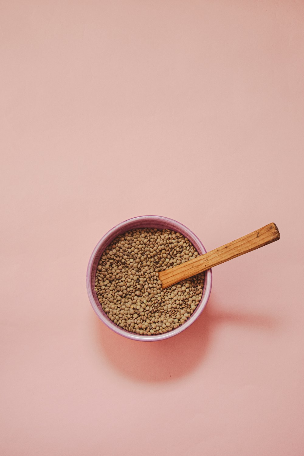 a bowl of food with a wooden spoon in it