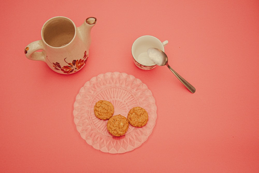 a plate of cookies next to a cup of tea