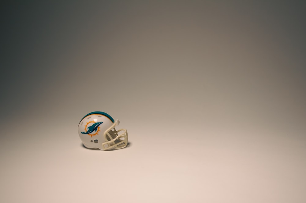 a football helmet sitting on top of a white table