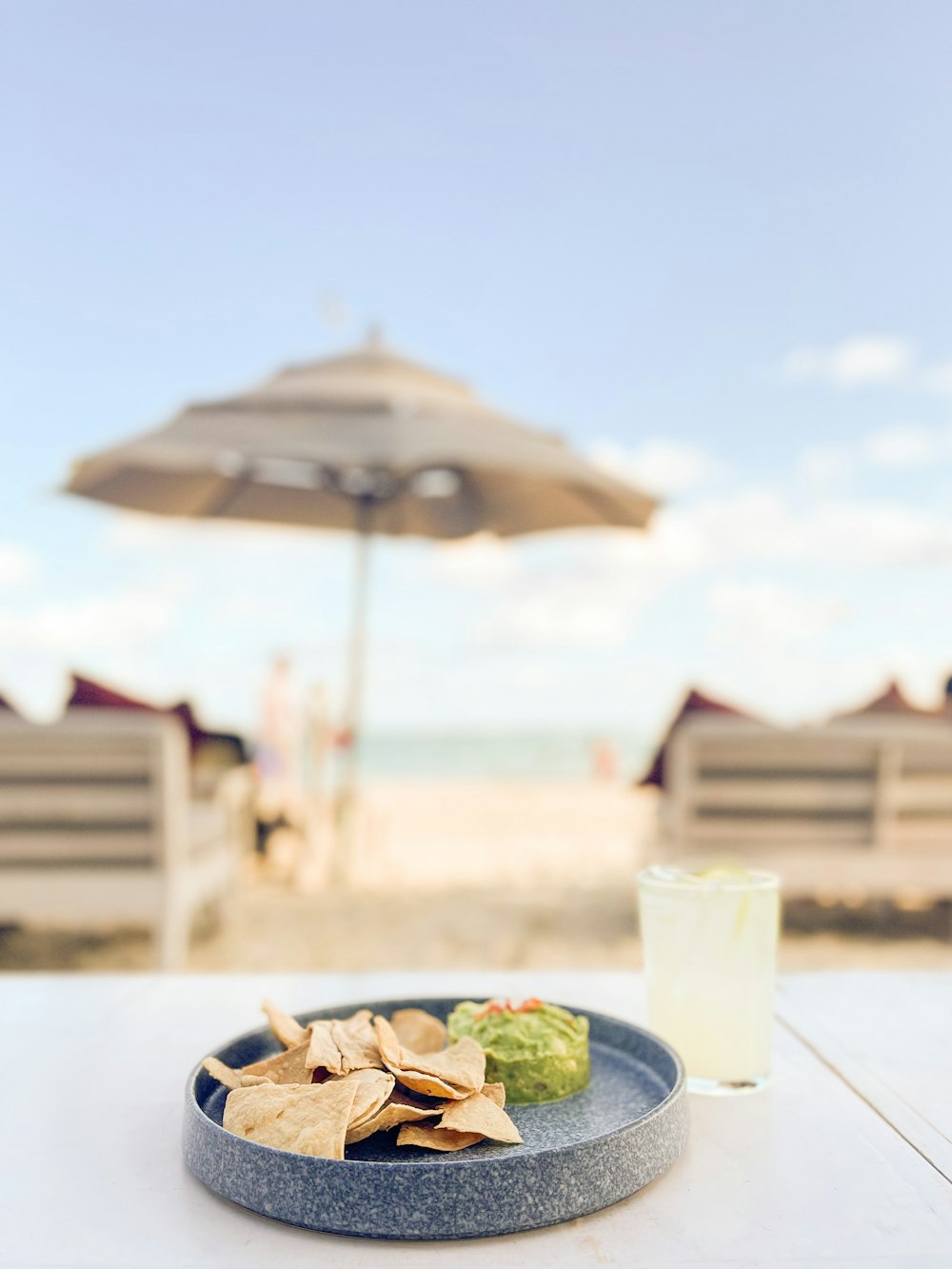 a plate of chips and a drink on a table