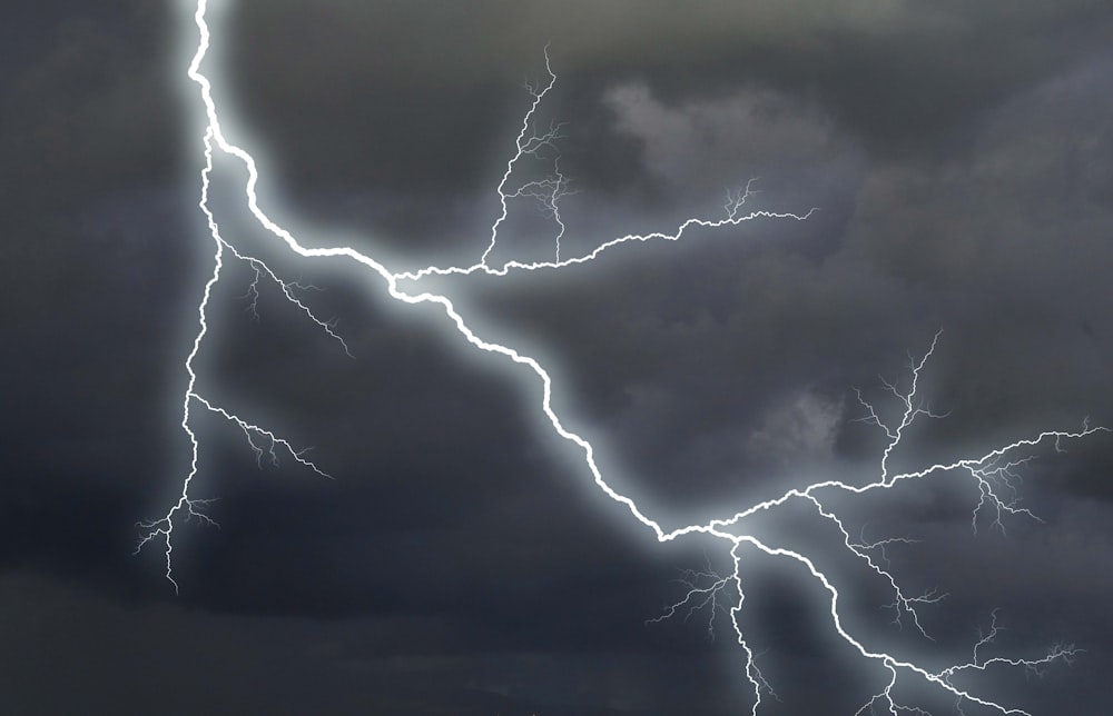 a lightning bolt strikes across a cloudy sky
