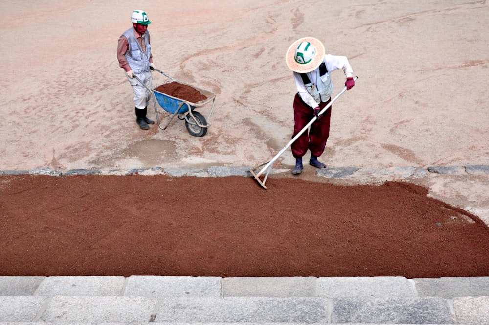 a couple of people that are standing in the dirt