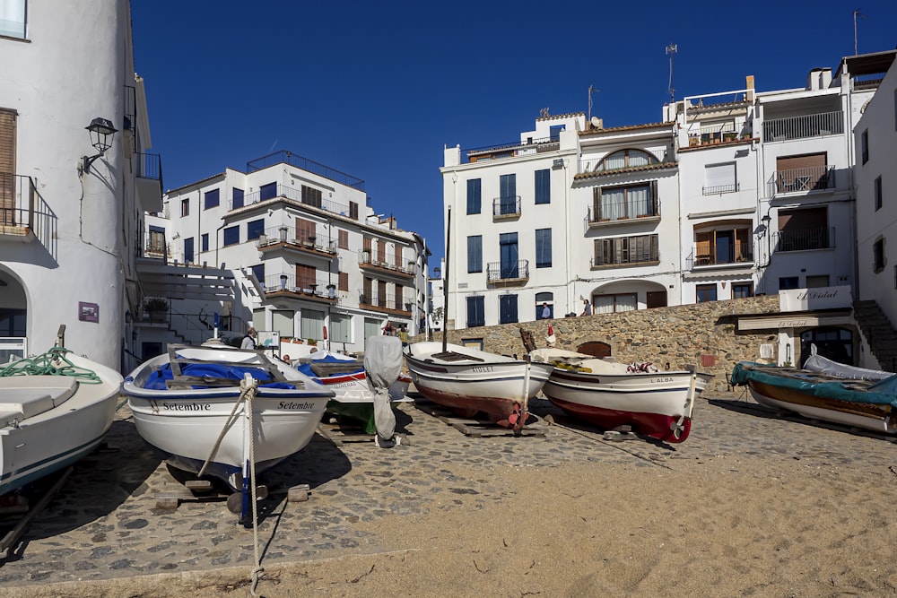 a group of boats sitting on top of a sandy beach