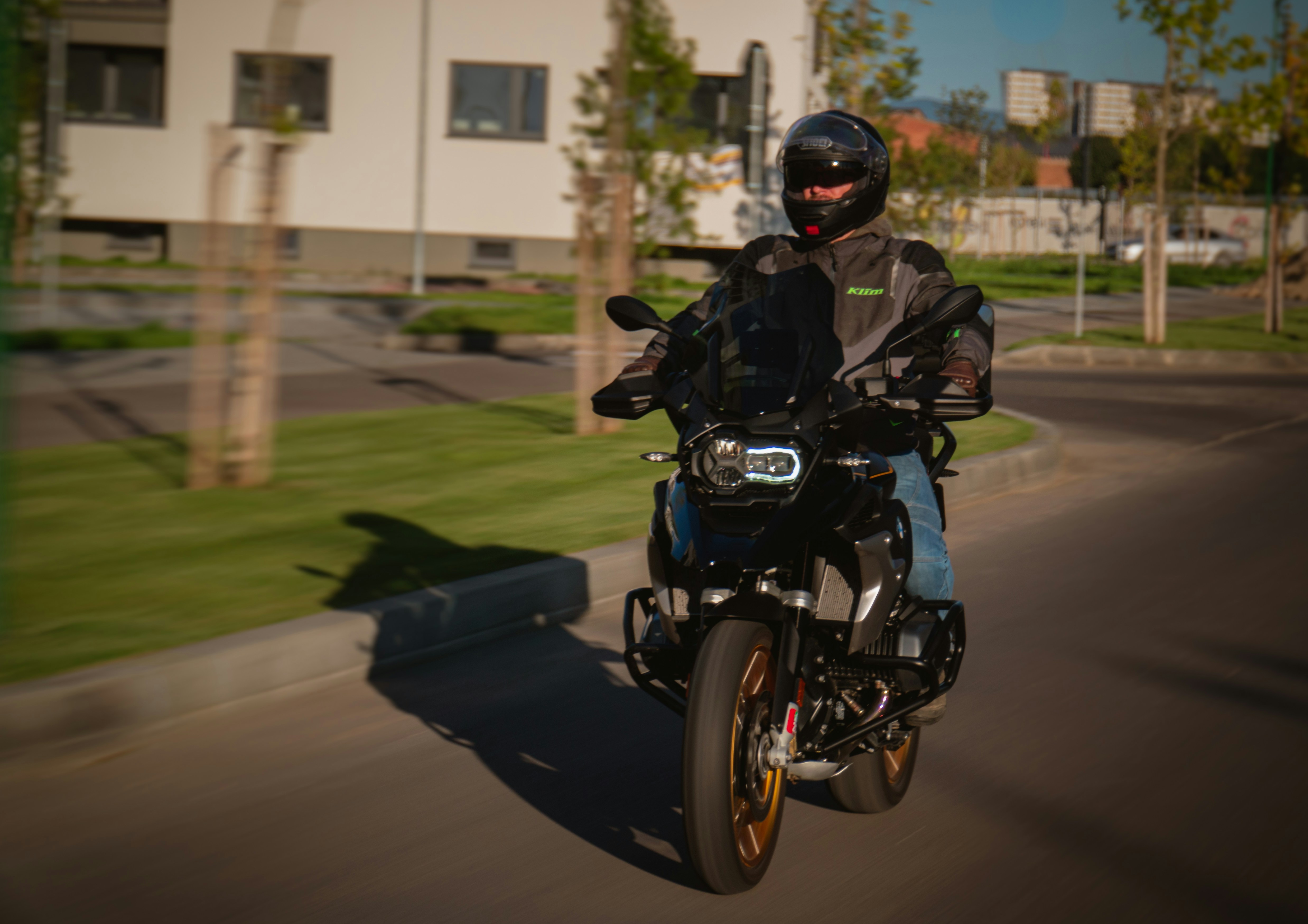 a man riding a motorcycle down a street