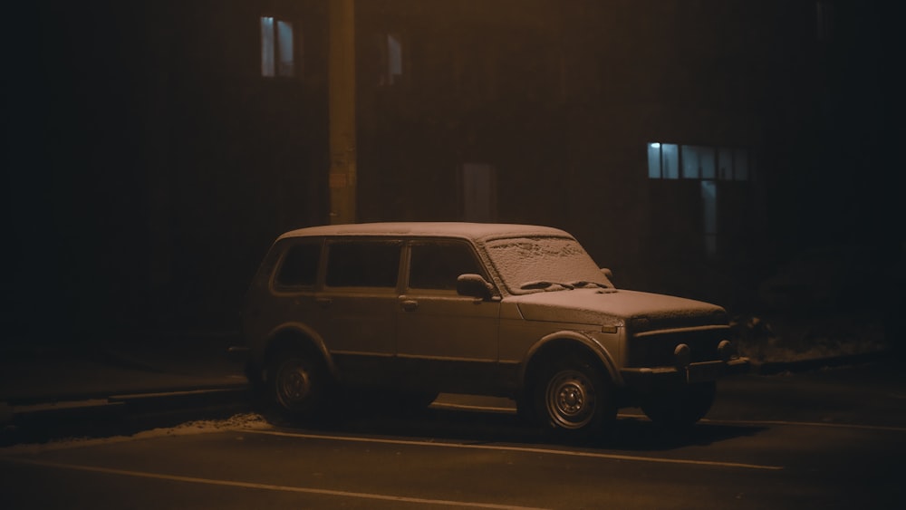 a car parked on the side of the road at night