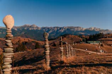 a stack of rocks sitting on top of a grass covered hillside