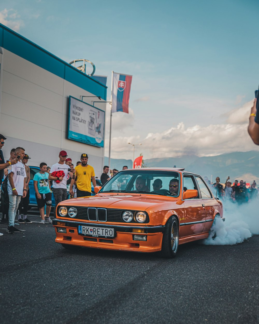 an orange car with a lot of smoke coming out of it