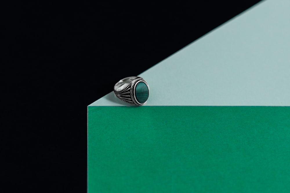ein Ring, der auf einem grün-weißen Block sitzt