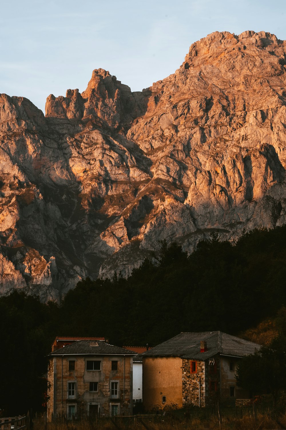 a house in front of a mountain range