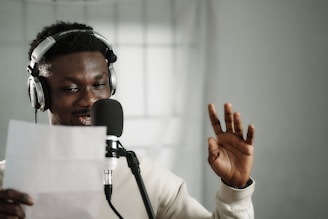 a man wearing headphones and holding a microphone