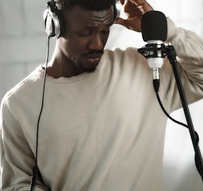 a man wearing headphones while holding a microphone