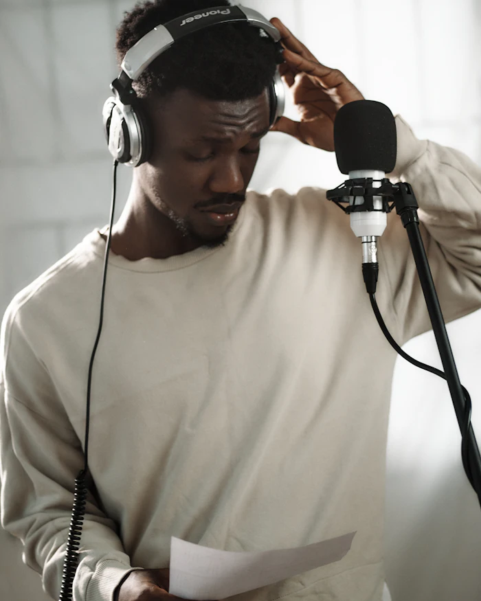 Interpreter wearing headphones and speaking into a microphone during a session