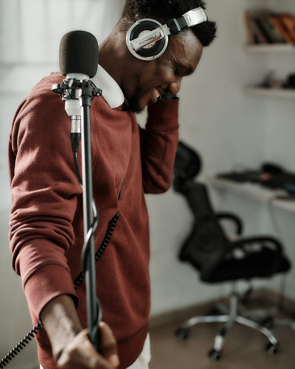 a man wearing headphones and holding a microphone