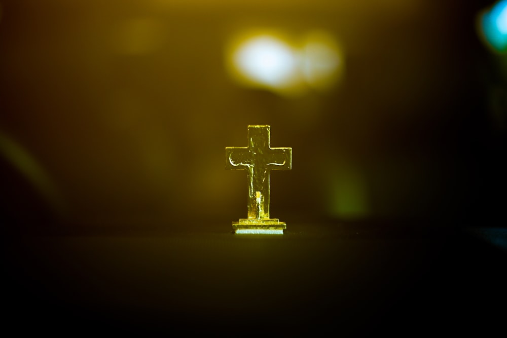 a glass cross sitting on top of a table
