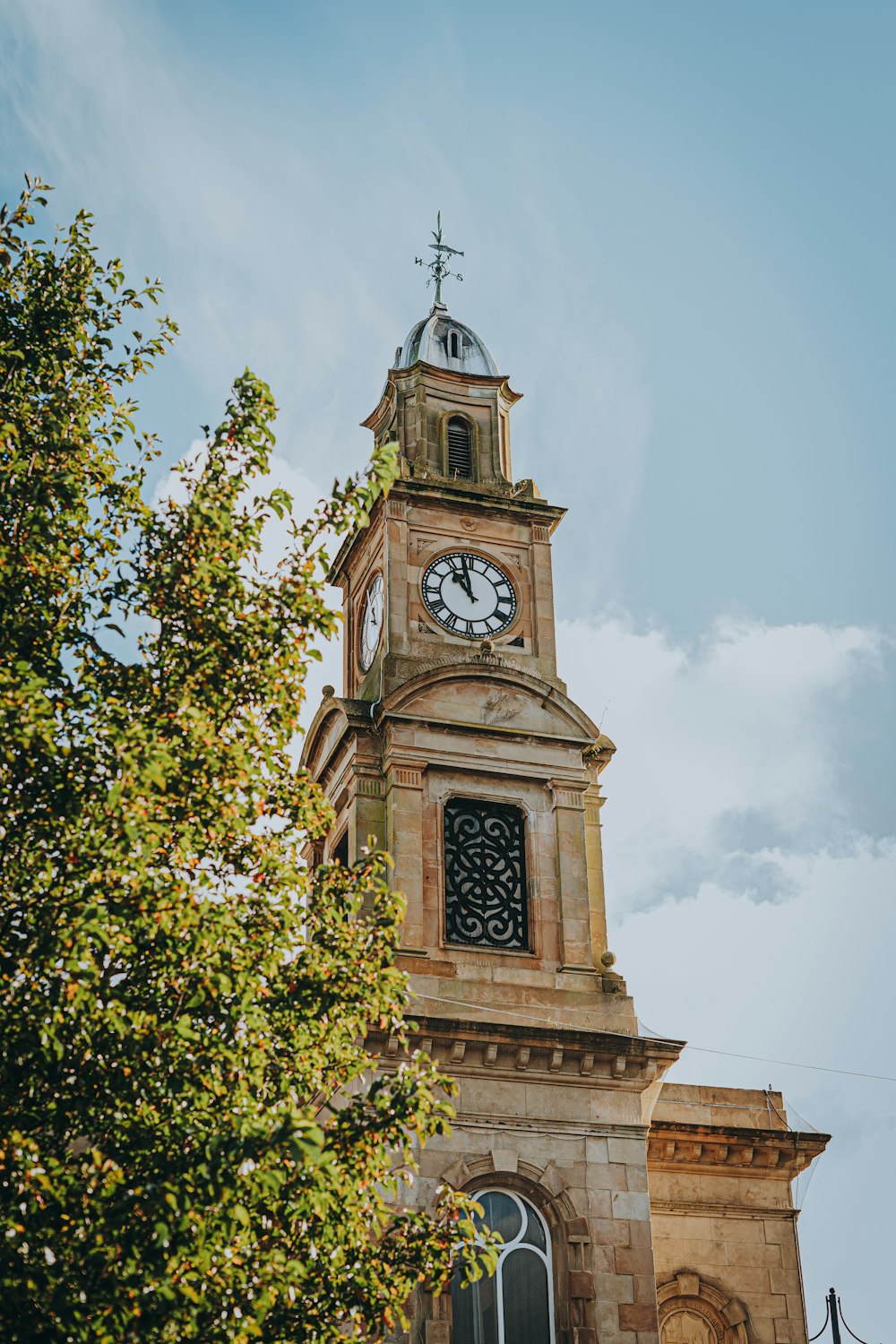 a tall clock tower with a clock on each of it's sides