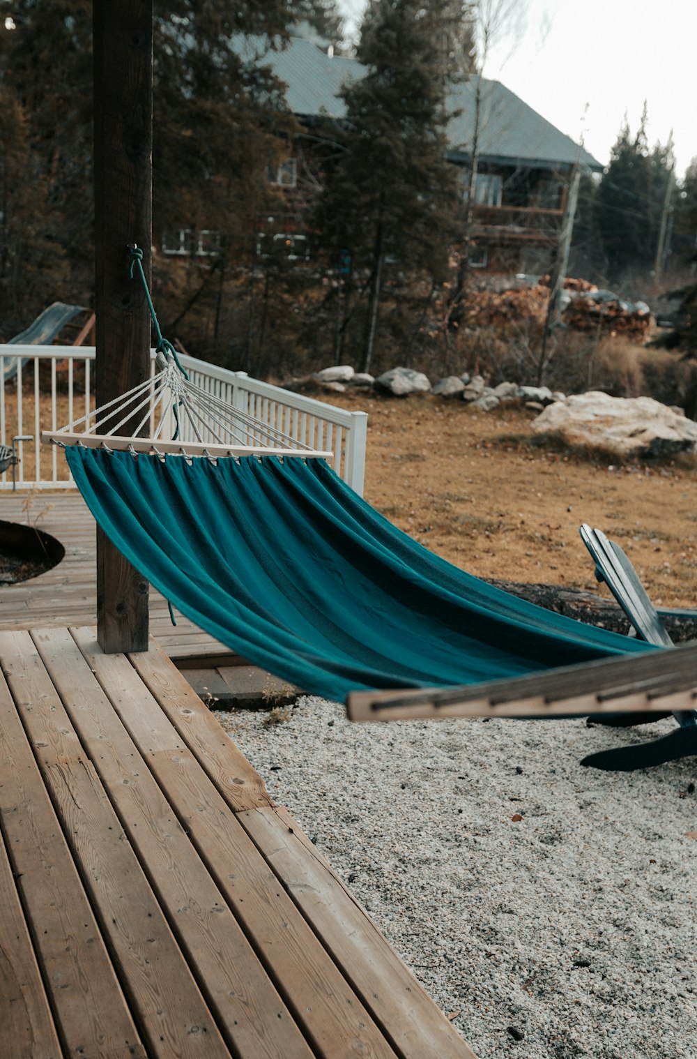 a blue hammock sitting on a wooden deck