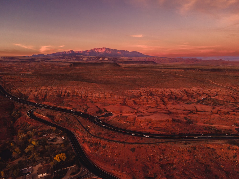 an aerial view of a winding road in the desert