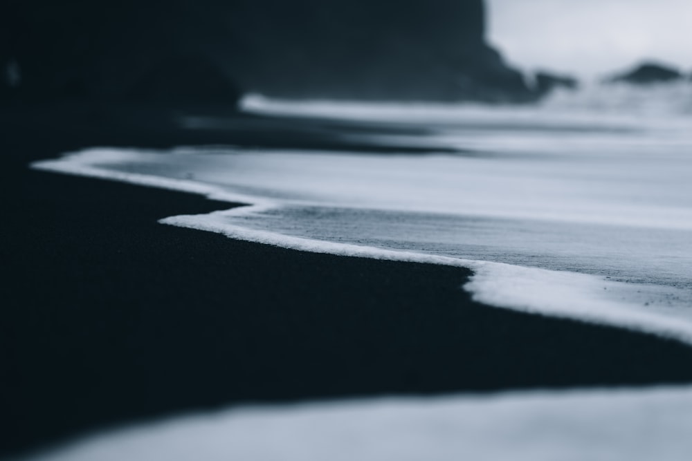 a black and white photo of a beach