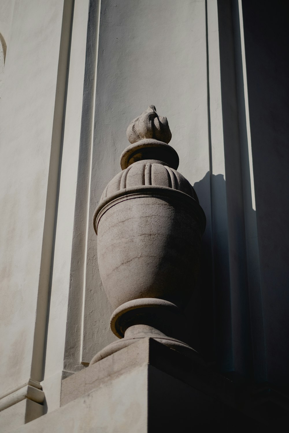 a close up of a vase on the side of a building