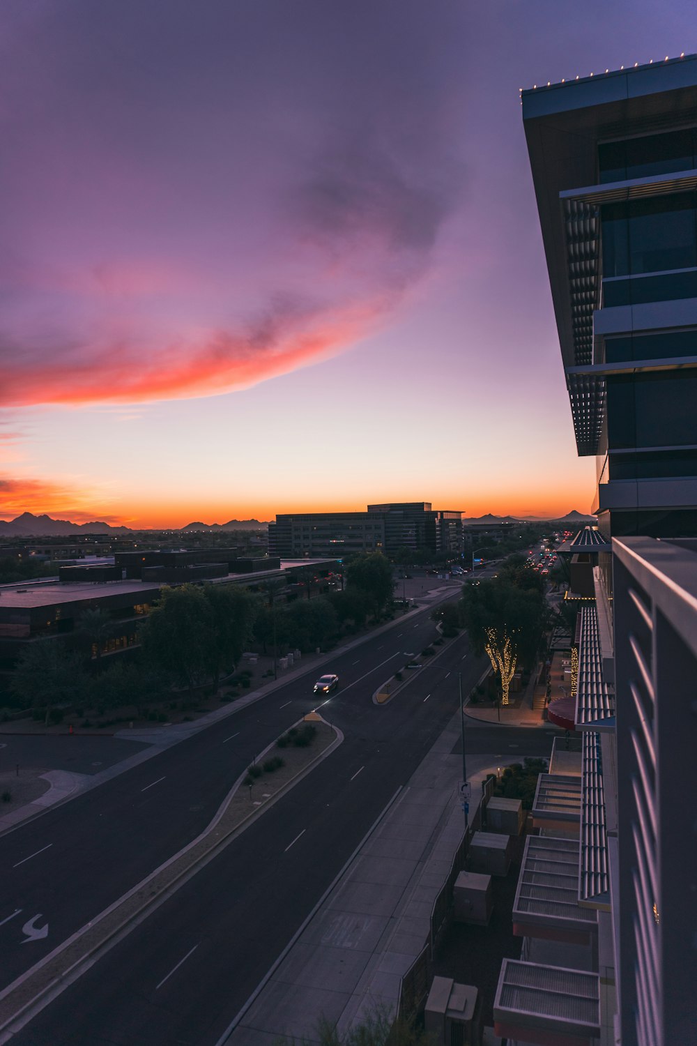 a sunset view of a street and a building