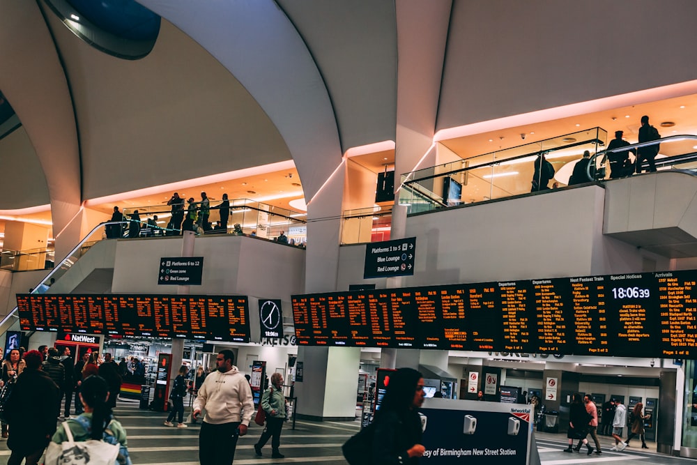 a group of people walking around an airport