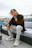 a man with dreadlocks sitting on a bench