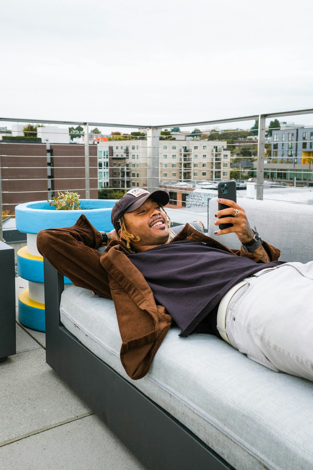 a man laying on a couch taking a picture of himself