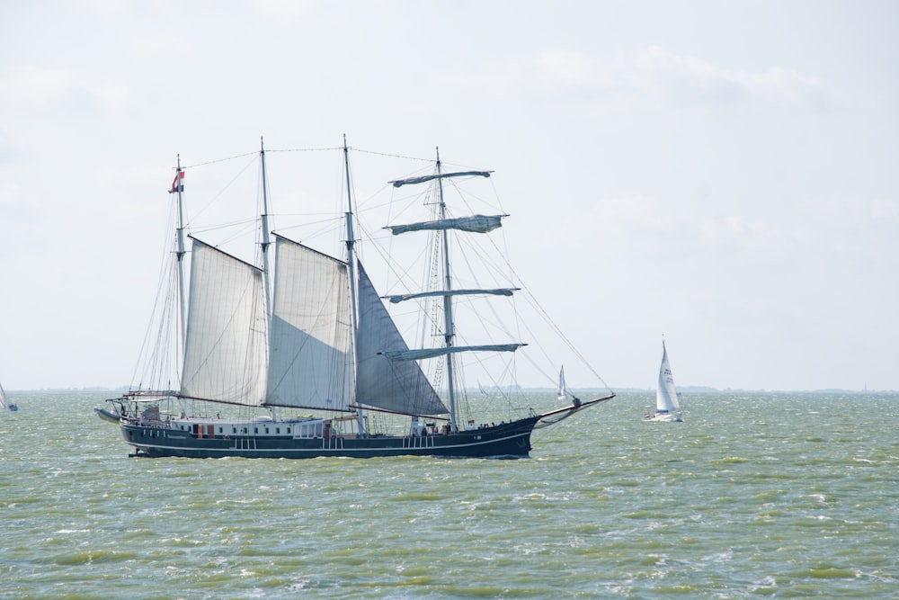 a sailboat sailing in the ocean on a sunny day