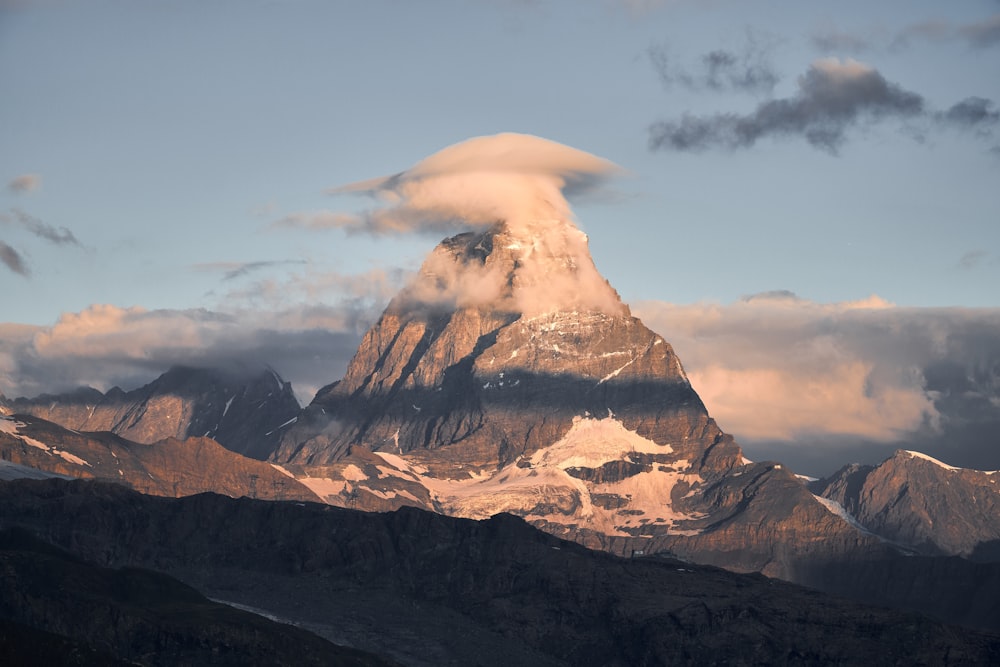 a very tall mountain with a cloud in the sky