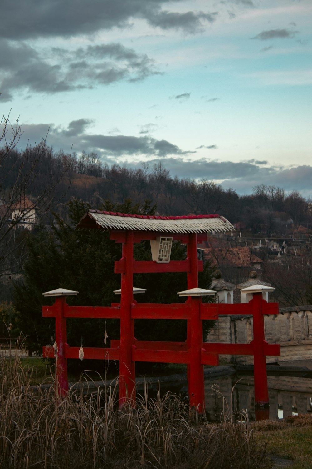 a red gate with a clock on top of it