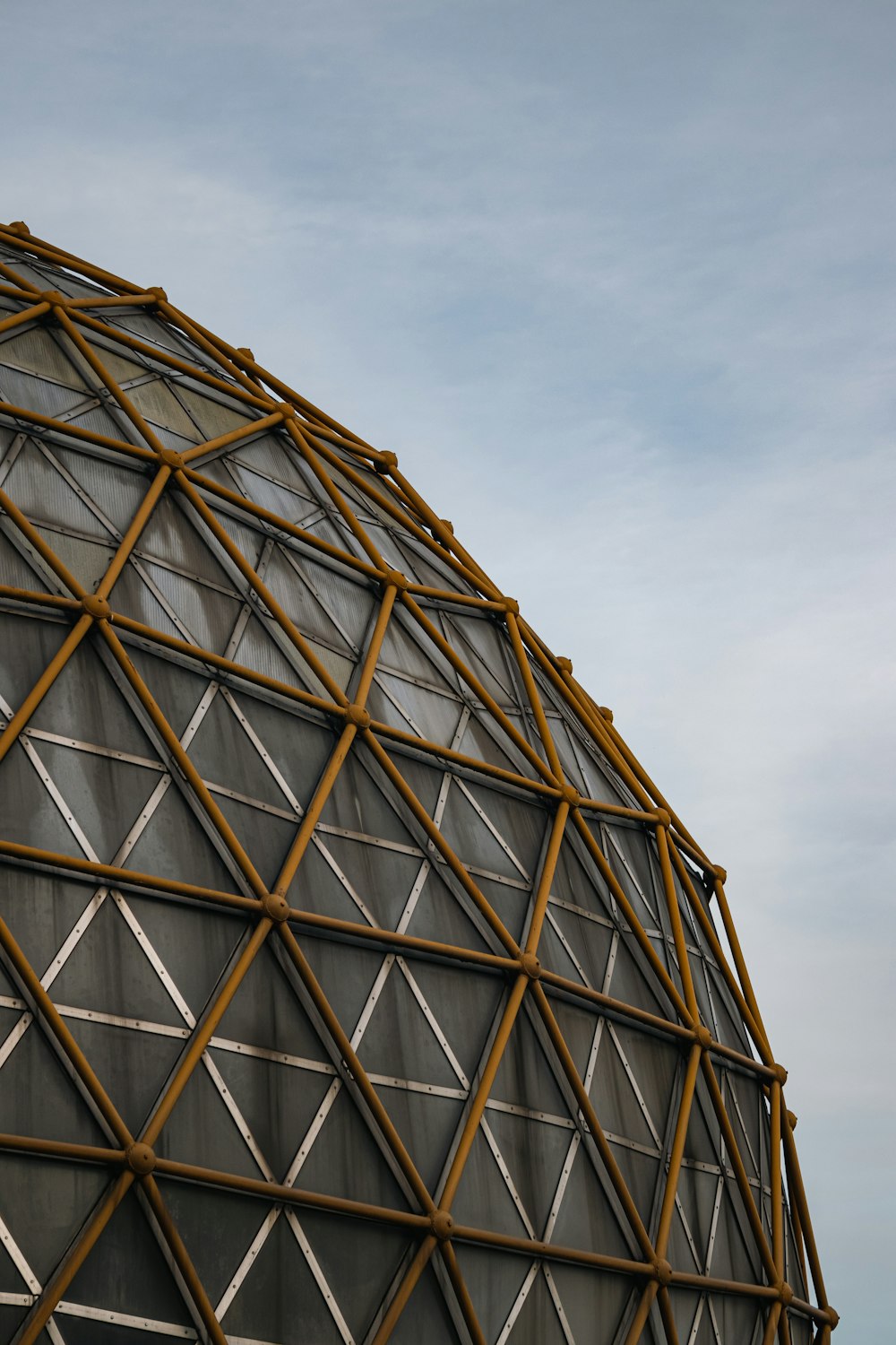 a close up of a metal structure with a sky background