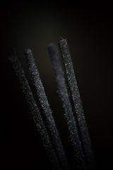 Close-up of hands inspecting premium bakhoor pieces in a traditional setting.