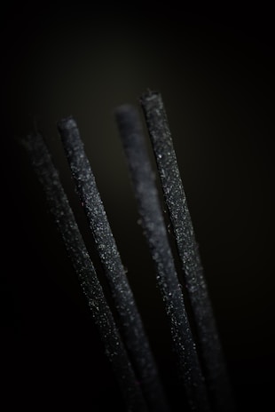 A close-up of hand-rolled incense sticks made from natural ingredients.