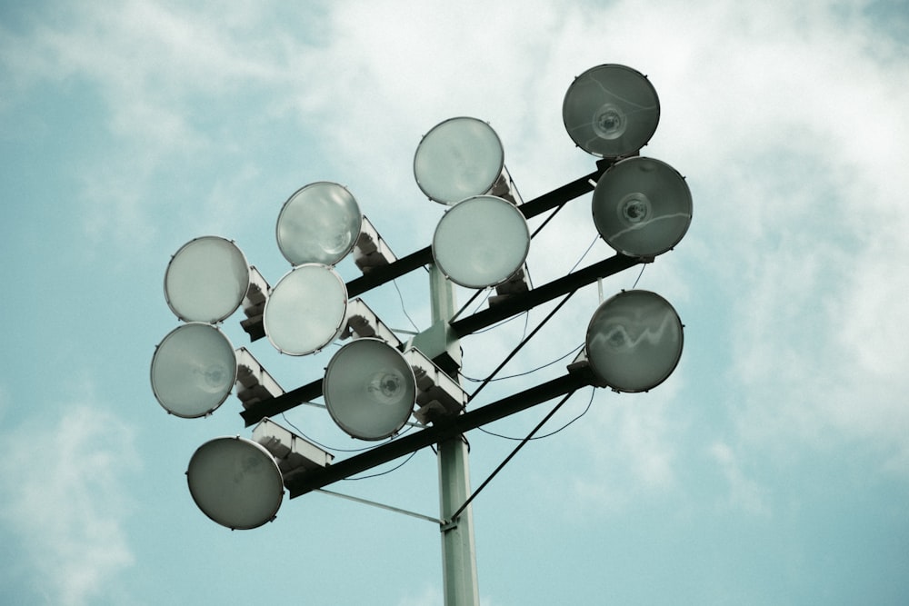 a close up of a street light with clouds in the background