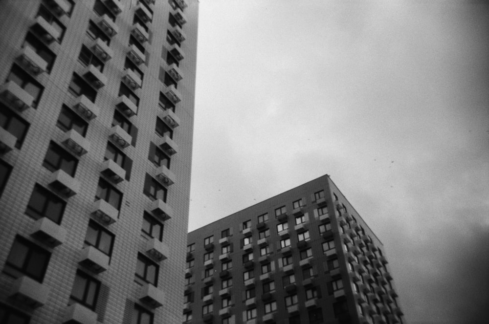 a black and white photo of two tall buildings