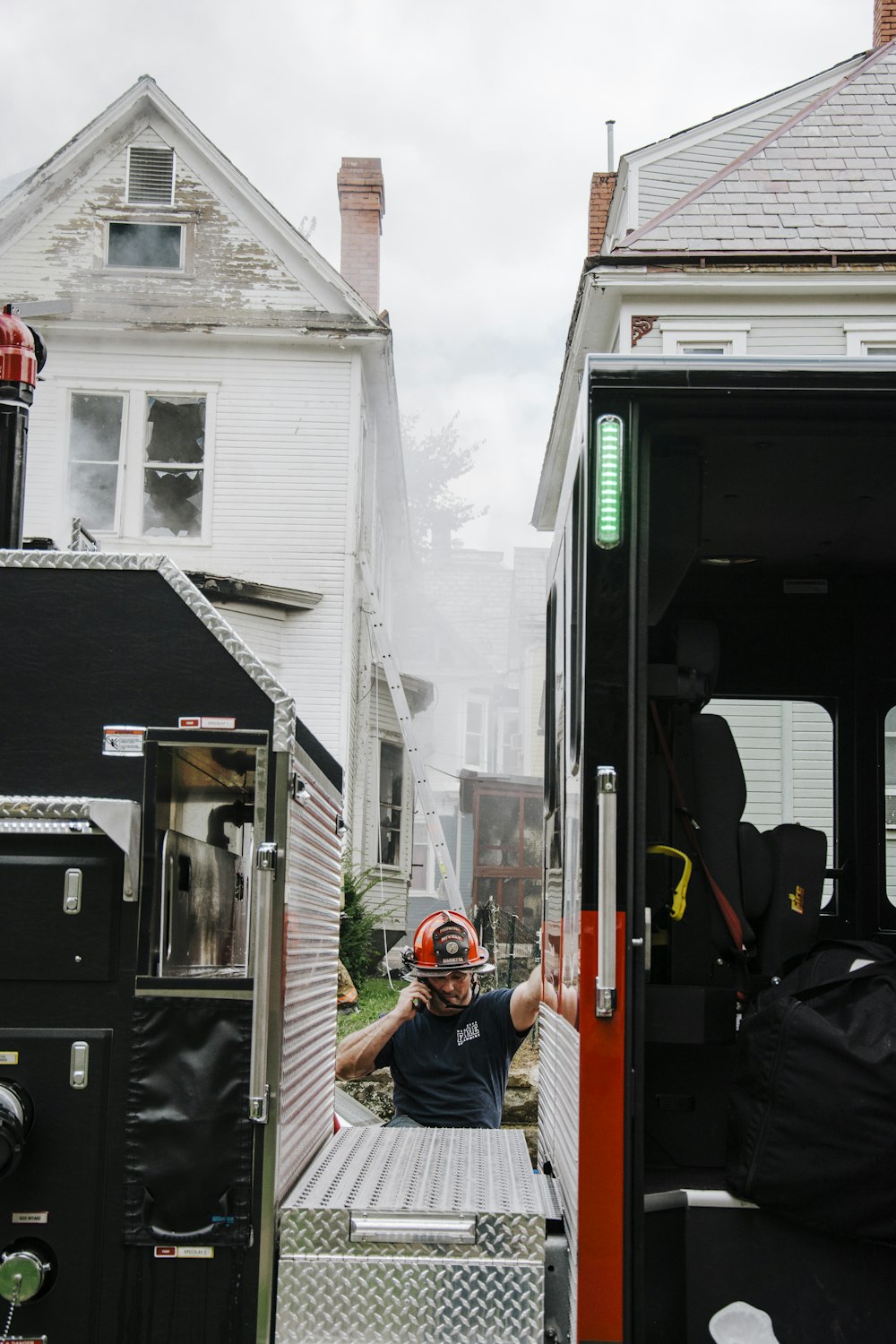 a man in a fireman's helmet standing in the back of a fire