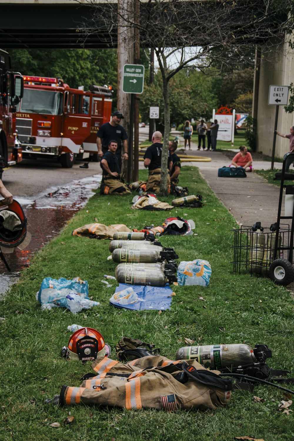 a group of fire fighters laying on the grass
