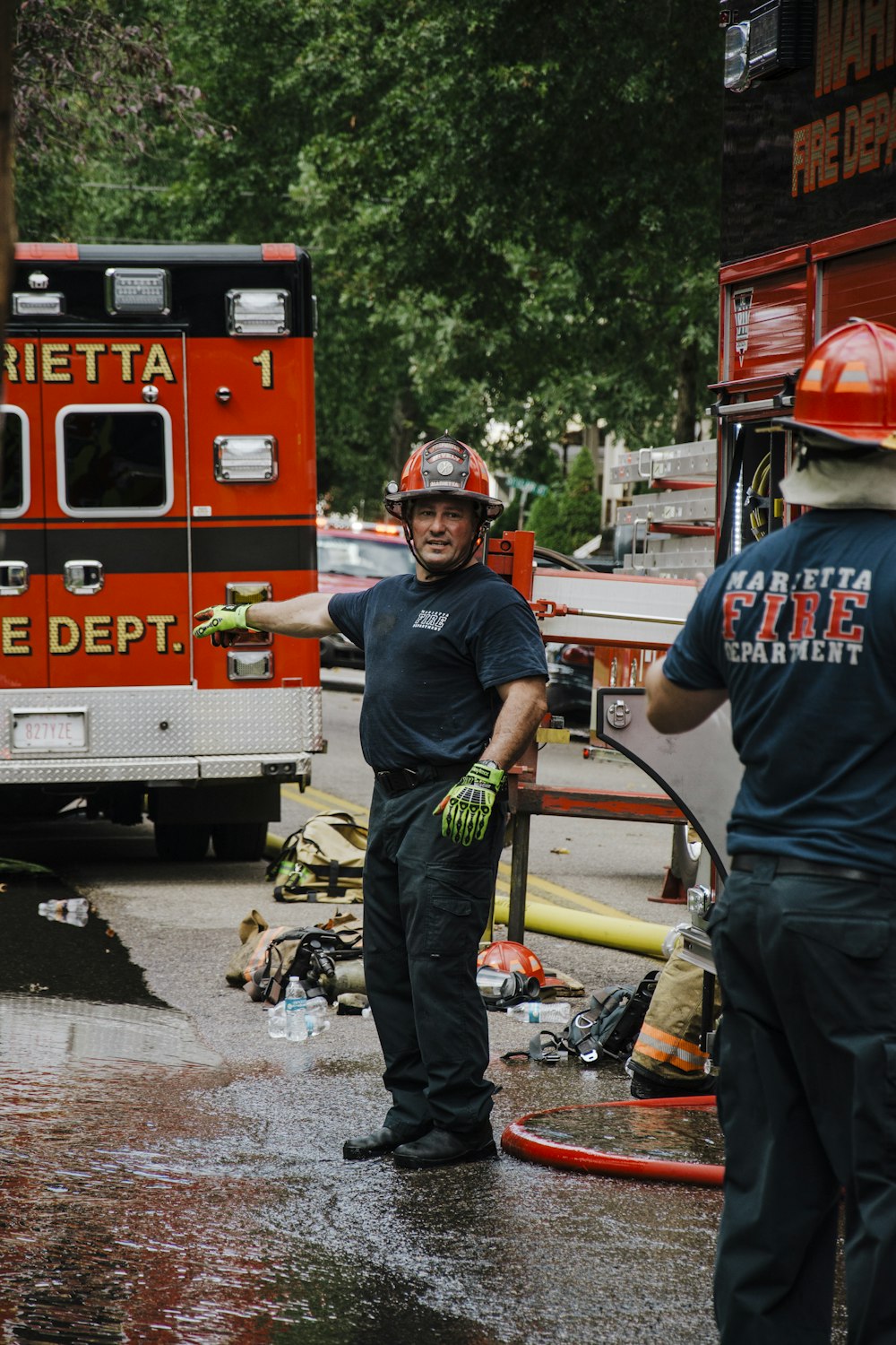 a couple of men standing next to a fire truck