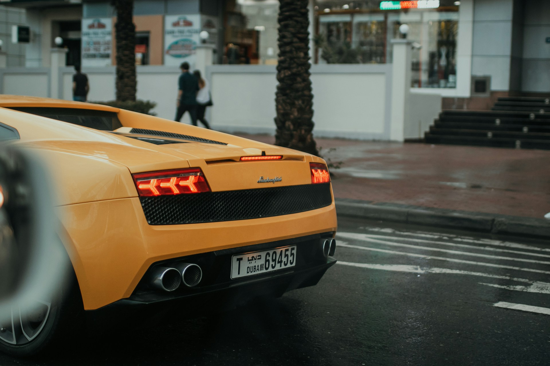 a yellow sports car parked on the side of the road