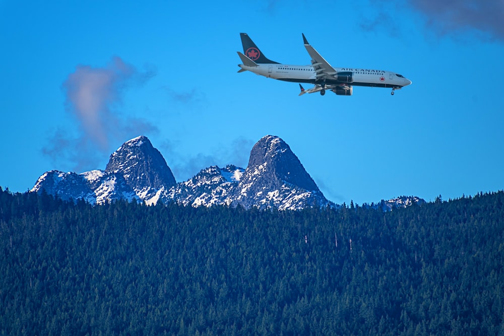 a plane is flying over a mountain range