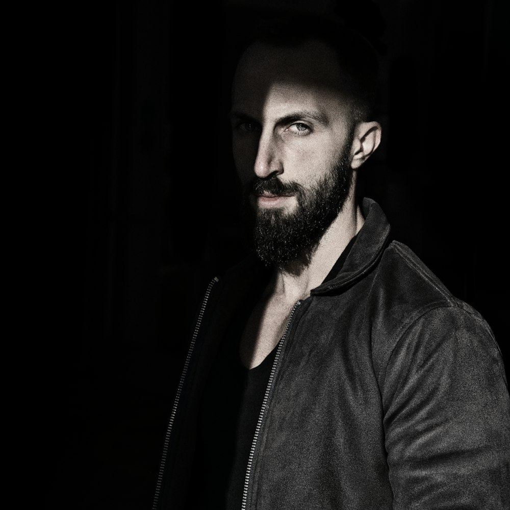 a man with a beard wearing a leather jacket