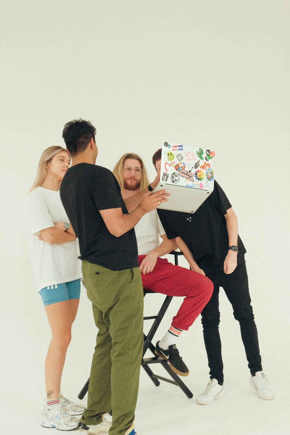 a group of people standing around a table with a cake on it