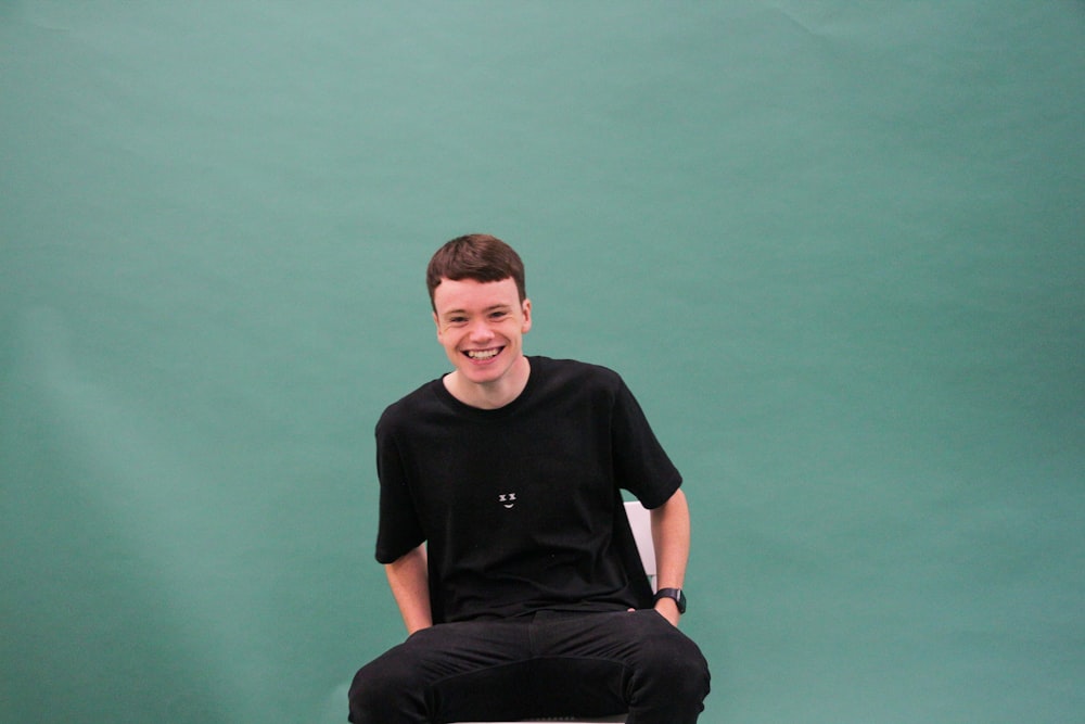 a man sitting on top of a tennis racquet