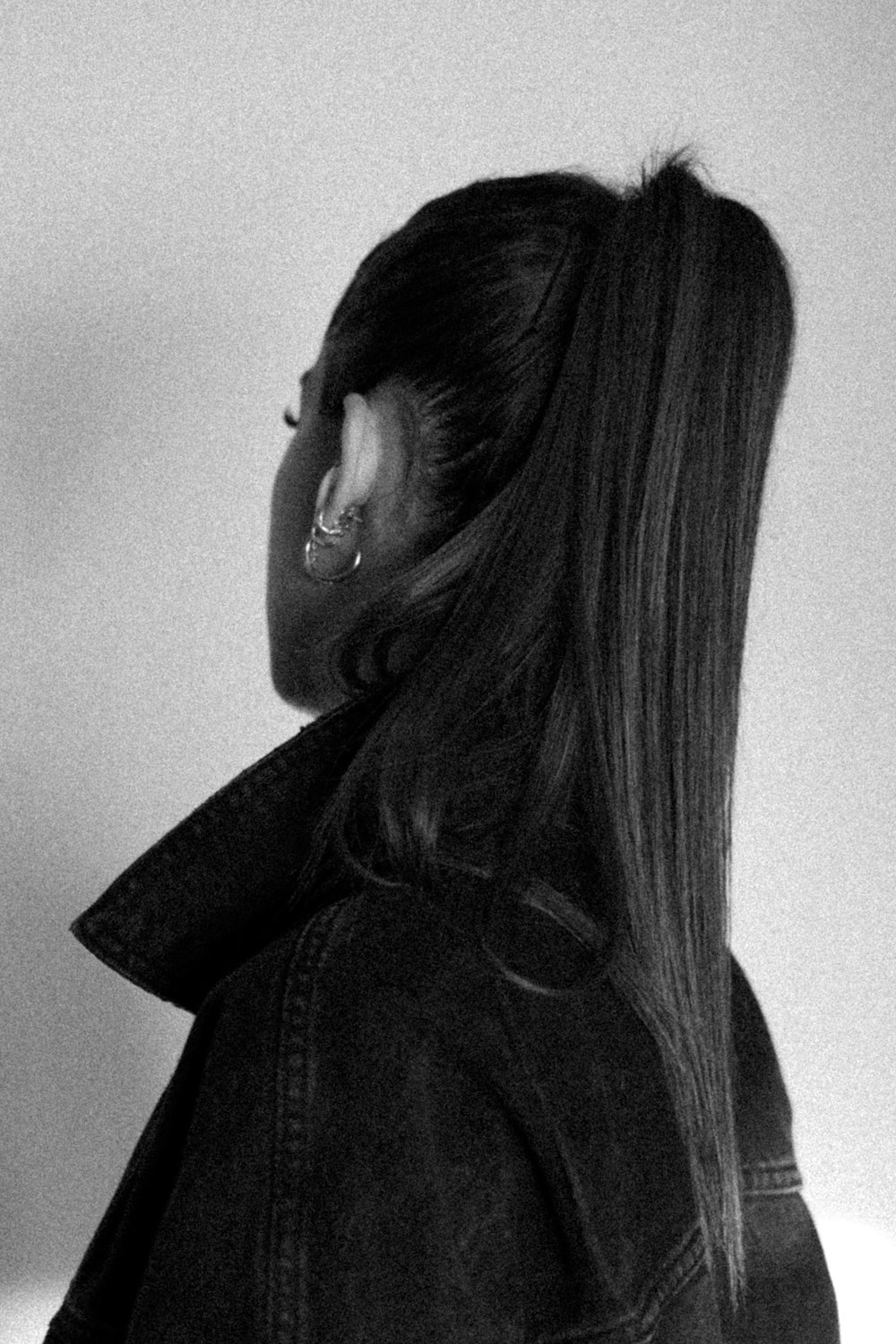 a black and white photo of a woman with long hair