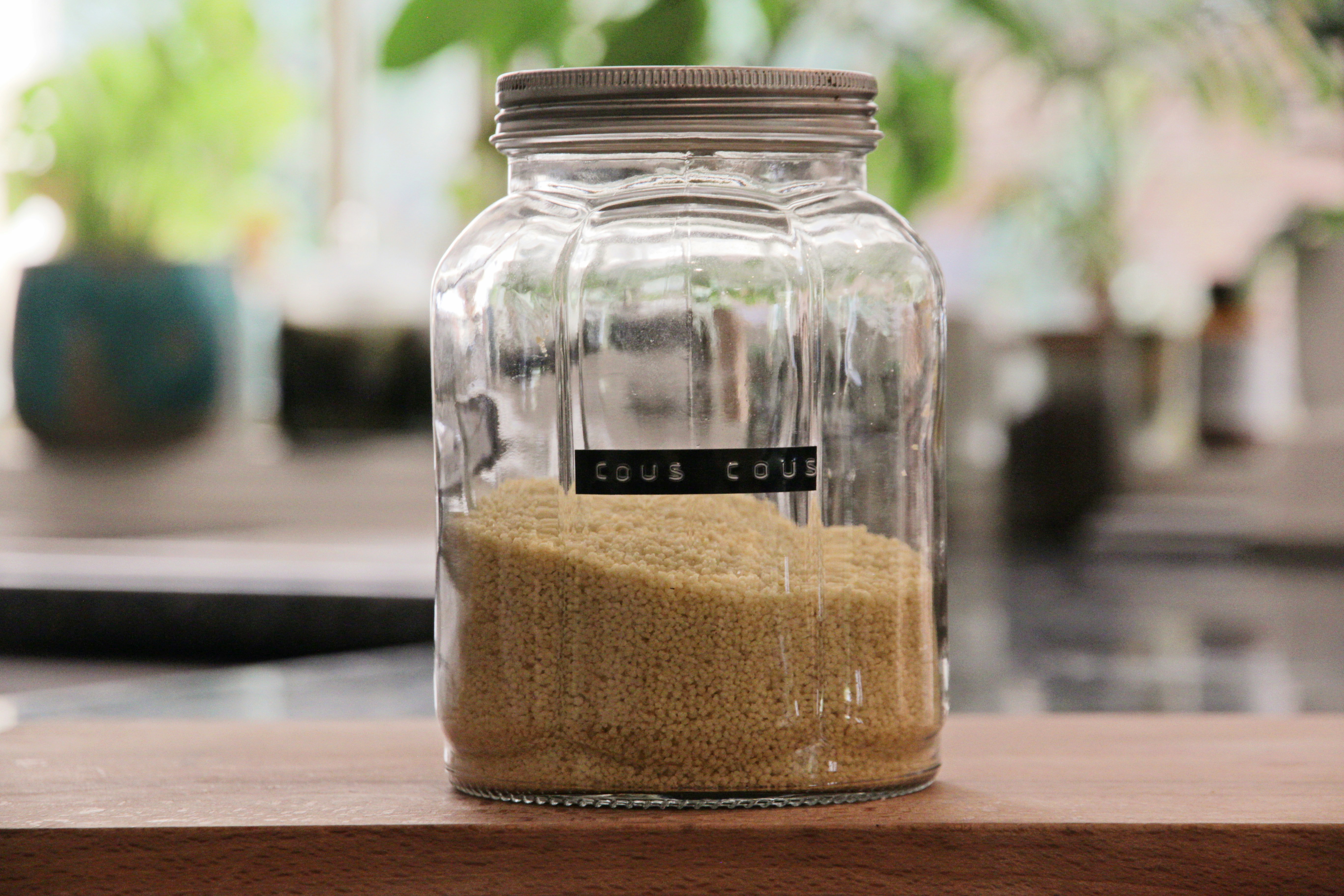 a jar filled with sand sitting on top of a wooden table